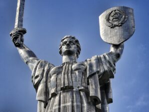 man holding sword and shield statue